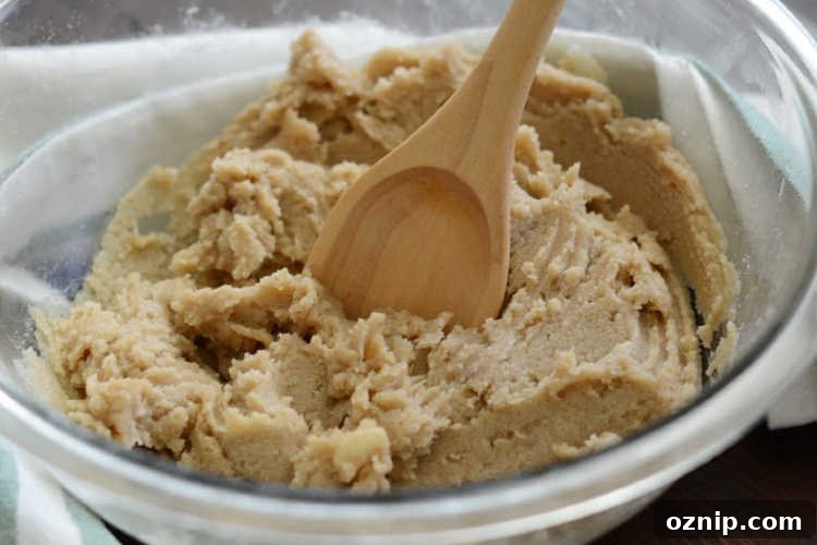mix cookie dough with wooden spoon.