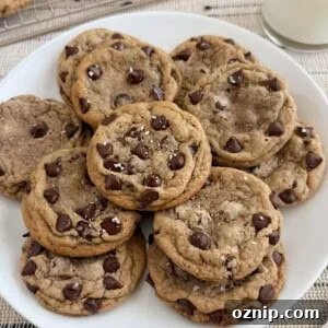 plate of chewy chocolate chip cookies with flaky salt on top.