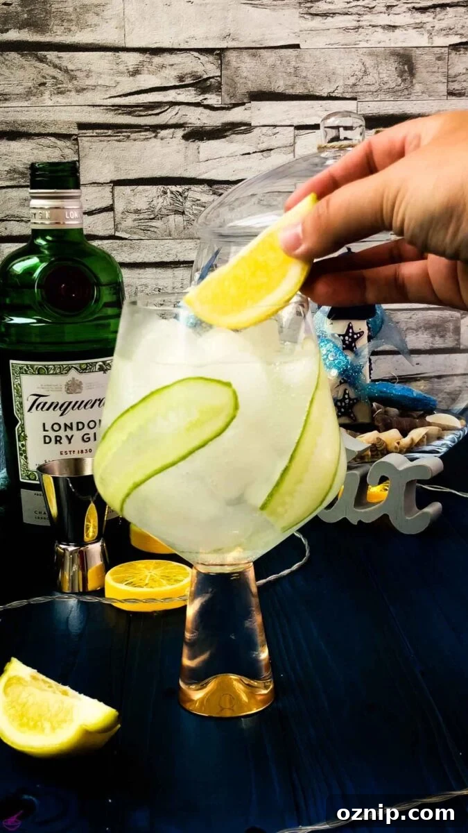 Add a lemon wedge on top of your cucumber gin and tonic.