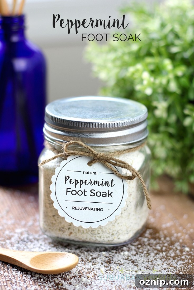 DIY Peppermint Foot Soak for Tired Feet 2 Peppermint foot soak in a glass jar with metal lid. It has a printable tag attached to the top with twine. There is a small wooden spoon in front of it.