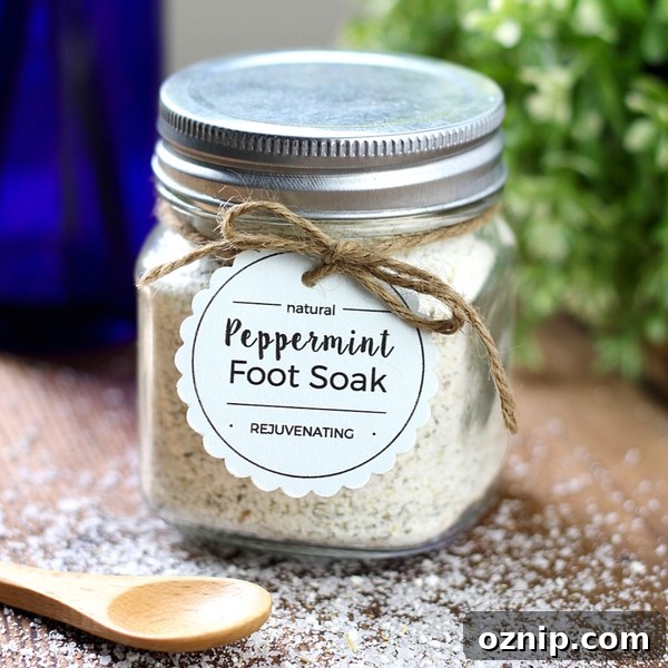 DIY Peppermint Foot Soak for Tired Feet 3 Peppermint foot soak in a glass jar with a wooden spoon in front of it.