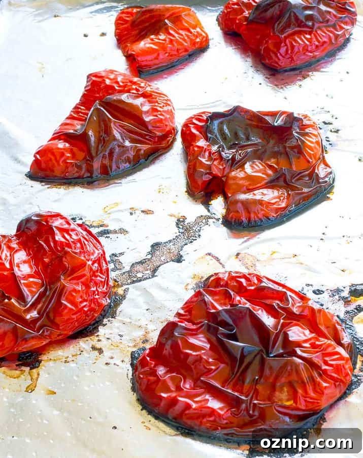 How to Roast Red Peppers: Oven, Grill and Stovetop Methods 2 Six roasted red pepper halves on a foil lined cookie sheet