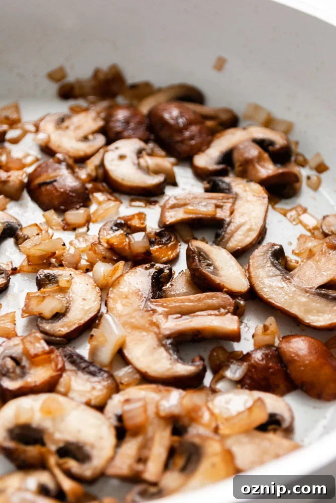Mushroom Omelette Recipe with Cheese and Herbs 3 Sautéing mushrooms and shallots in a skillet.