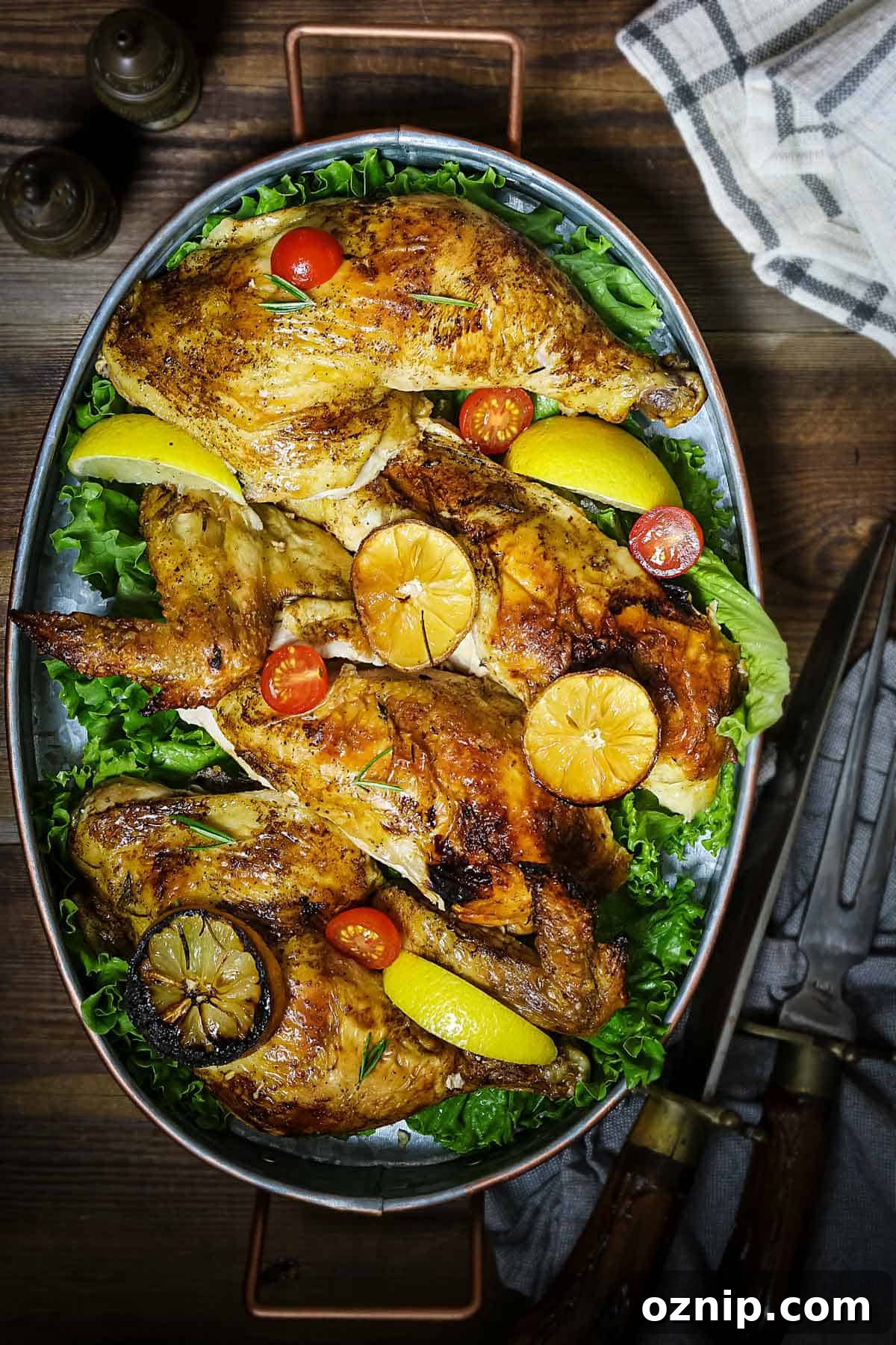 Pieces of roasted chicken in an oval platter on a table
