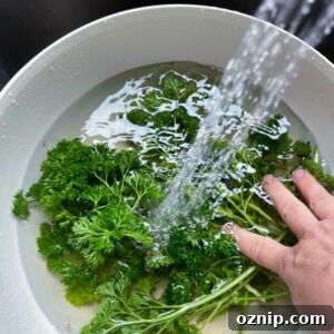 water running into bowl with parsley