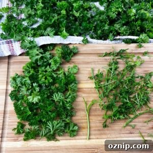 tender leaves in pile next to pile of stems on cutting board