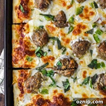 overhead shot of meatball pizza in baking sheet