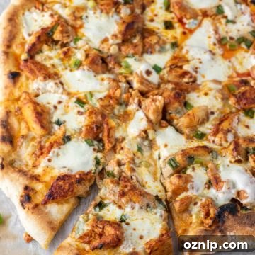 slice of buffalo chicken pizza pulled on parchment paper