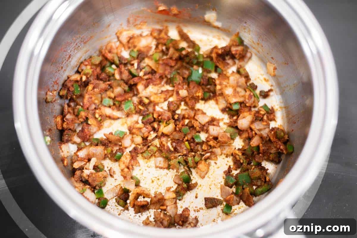 Spices cooking with veggies in pot.