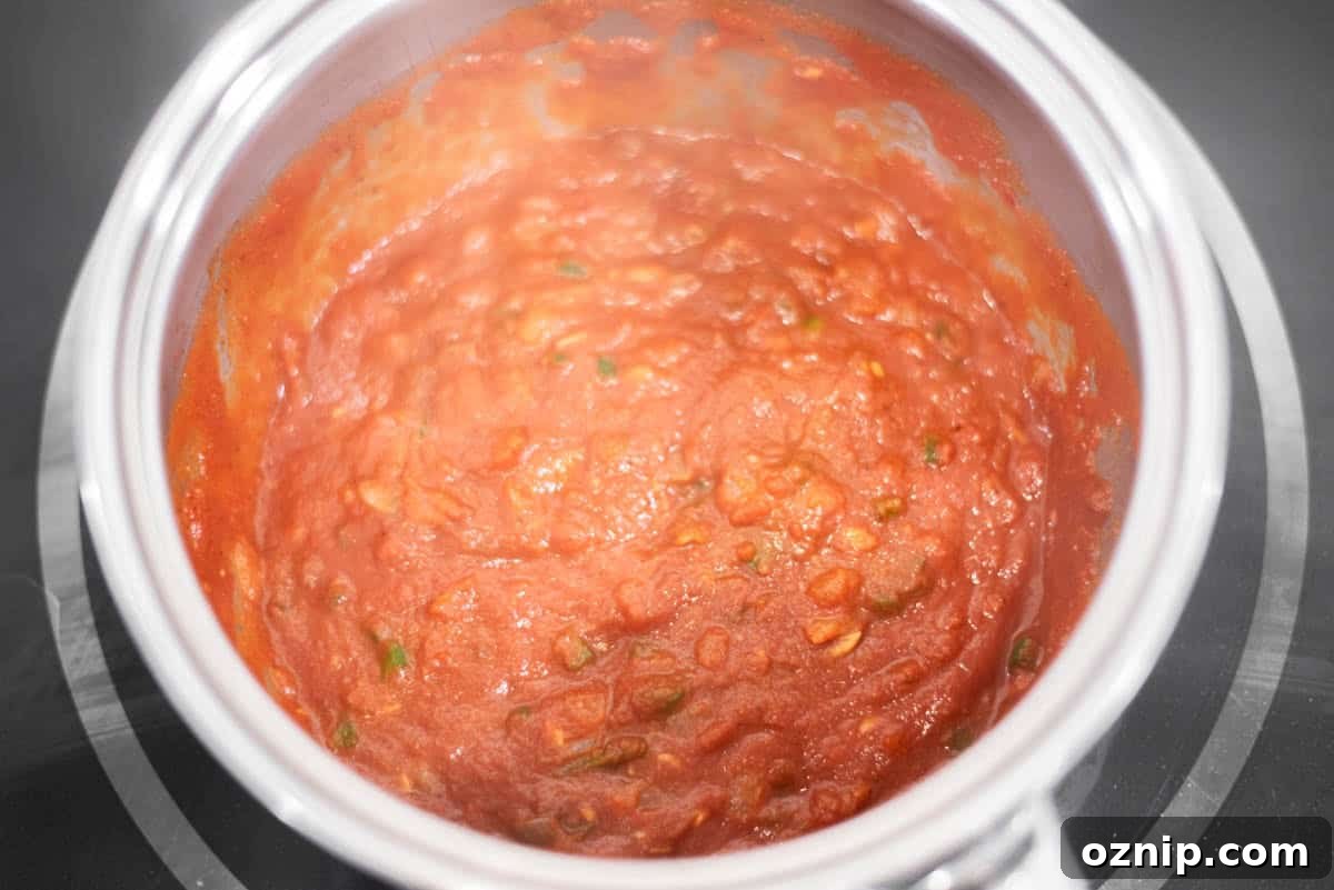 Tomato sauce added to pot and simmering.