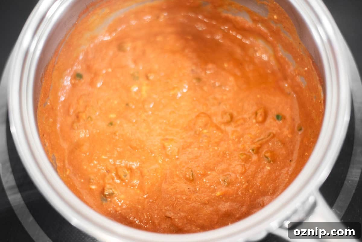 Cream and yogurt added to sauce and simmering.