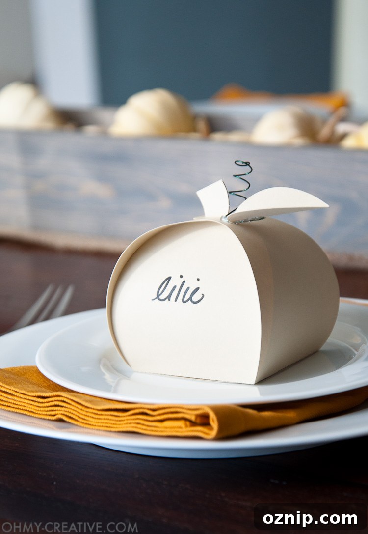 Make these easy paper pumpkins for your Thanksgiving table or any DIY Thanksgiving decorations. You can fill them with treats, use them as a place card, or just put them on your mantle to decorate. | OHMY-CREATIVE.COM