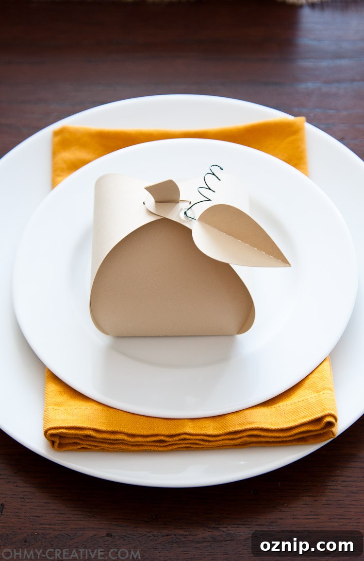 Make these easy paper pumpkins for your Thanksgiving table or any DIY Thanksgiving decorations. You can fill them with treats, use them as a place card, or just put them on your mantle to decorate. | OHMY-CREATIVE.COM