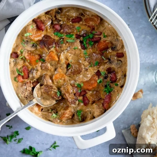 Overhead image of creamy pork and bacon casserole in a white casserole pan.