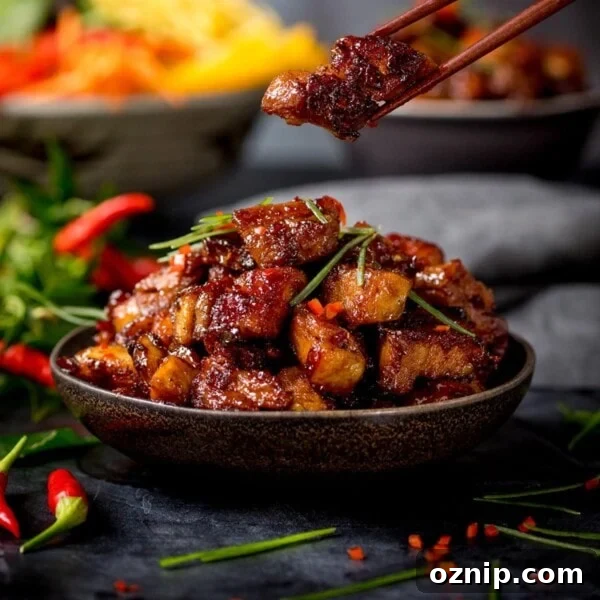 Close up image of bowl of Chinese sticky pork belly pieces.
