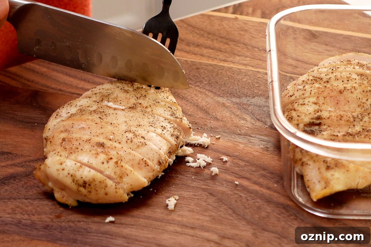 A woman slicing a chicken breast.