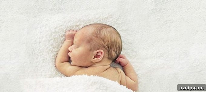 A baby lying on a bed.