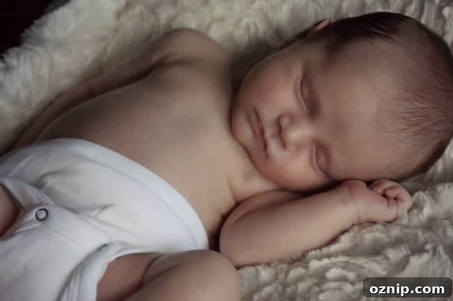 A baby lying on a bed.