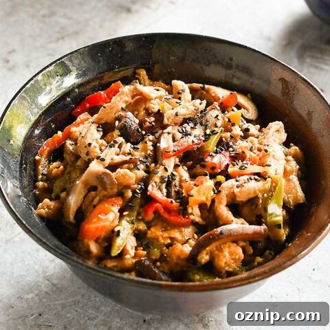 Date Sweetened Teriyaki Soy Curls in a brown ceramic bowl with 2 rice bowls
