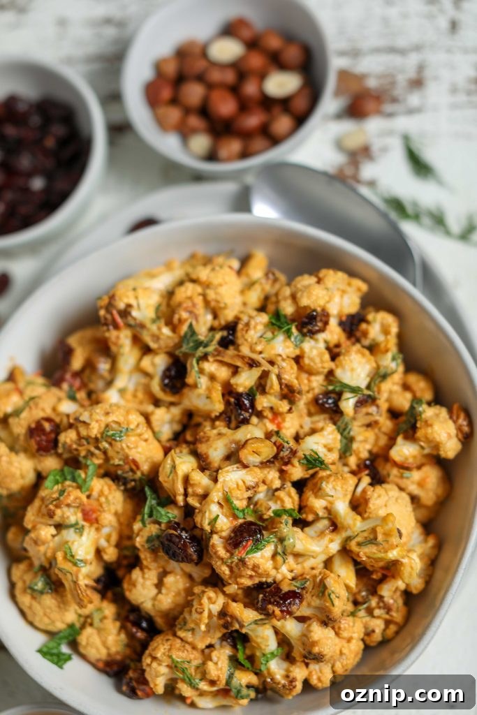 Plant-Based Thanksgiving Sides Your Guests Will Love 6 Harissa Roasted Cauliflower with Cranberries & Hazelnuts by Flora & Vino