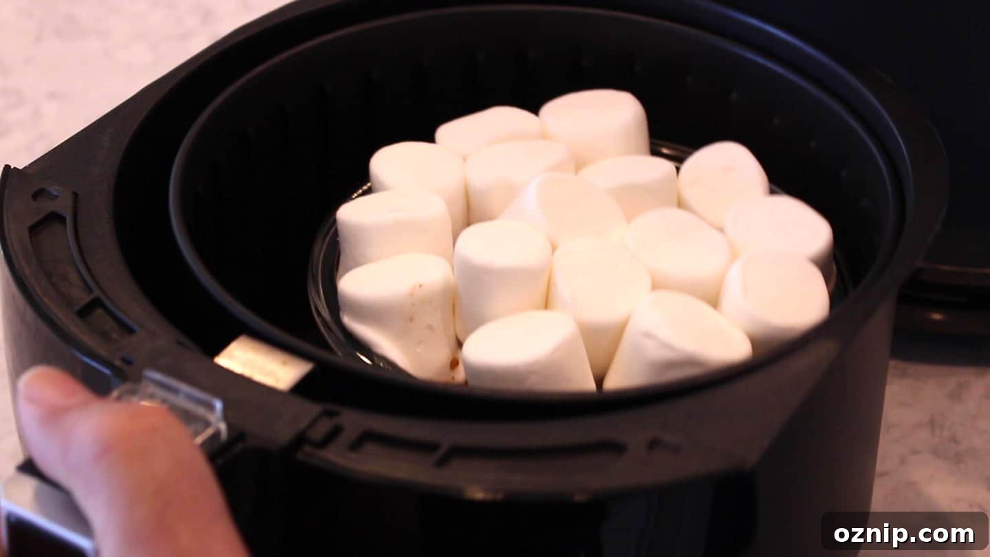 adding marshmallows on candied yams in an air fryer