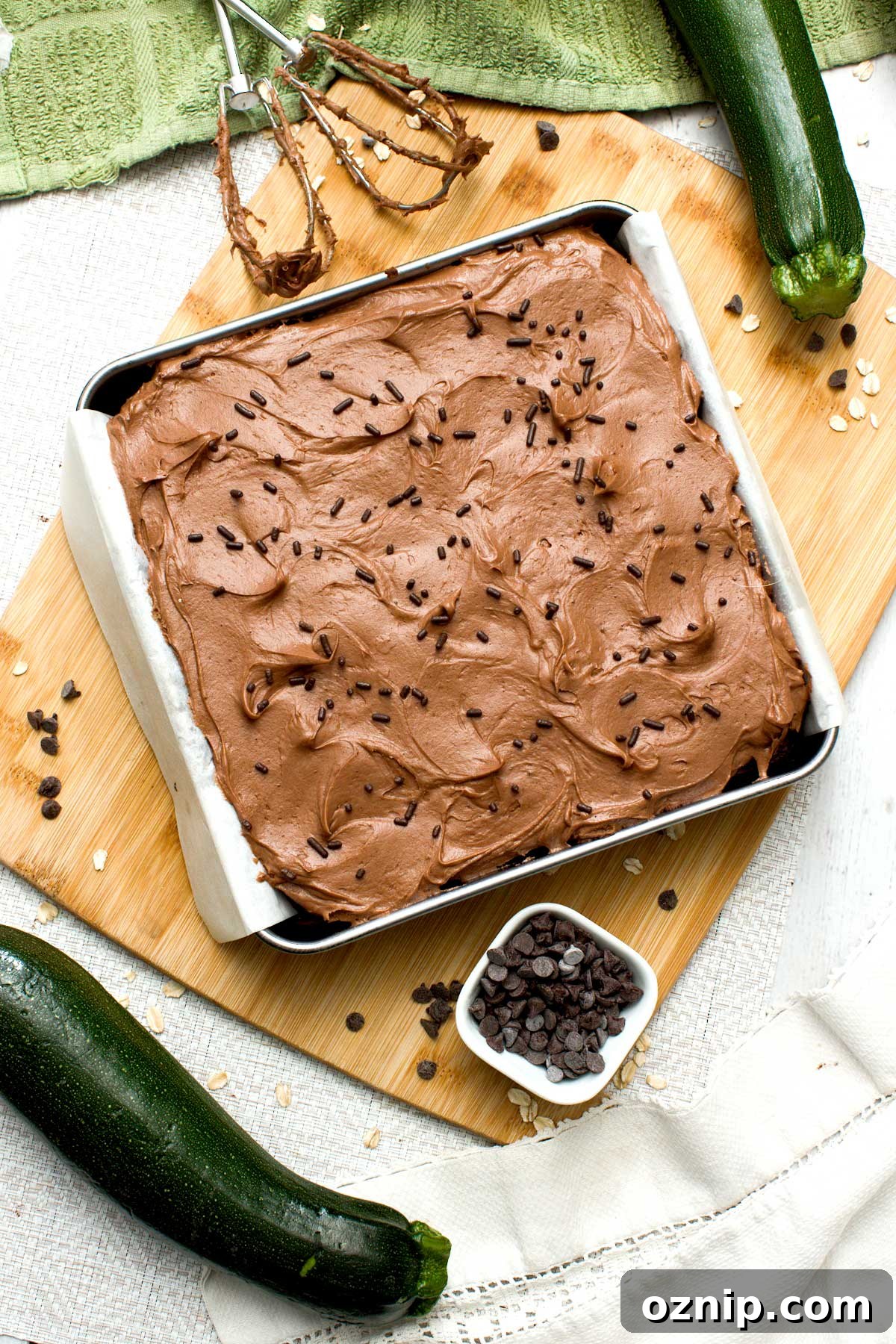 The top view of a gluten-free chocolate zucchini cake with cream cheese frosting.