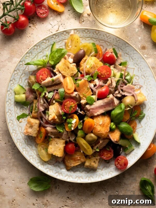 An overhead shot of a tuna panzanella salad on a large plate