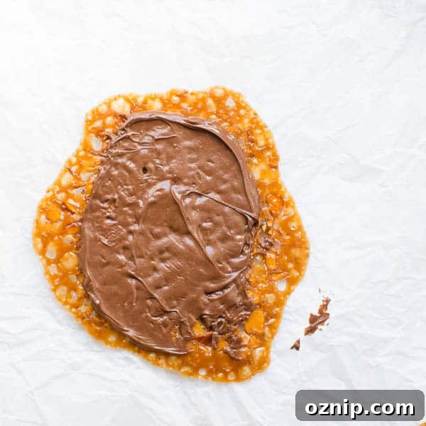spreading chocolate on a Florentine.