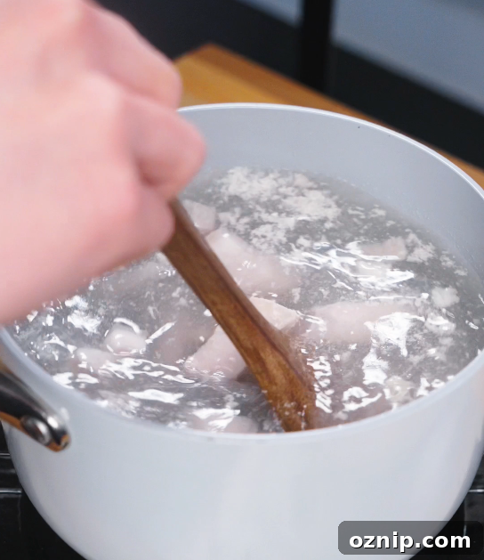Chinese Red Braised Pork Belly Recipe 4 Cubed pork belly being blanched in boiling water to remove impurities, an essential first step for clean flavor and tender red braised pork.