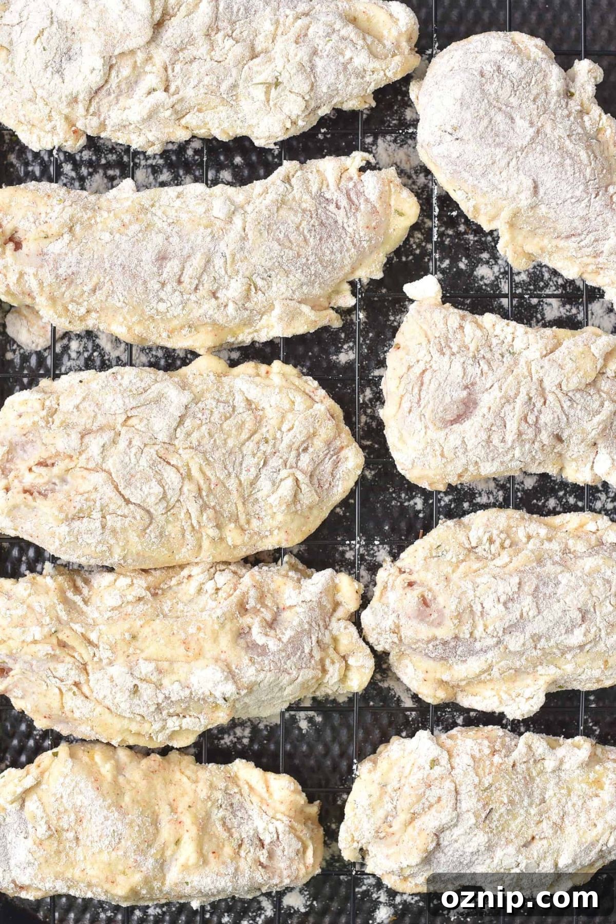 Gluten-Free Fried Chicken Recipe (Dairy-Free) Flour coated chicken on wire rack.