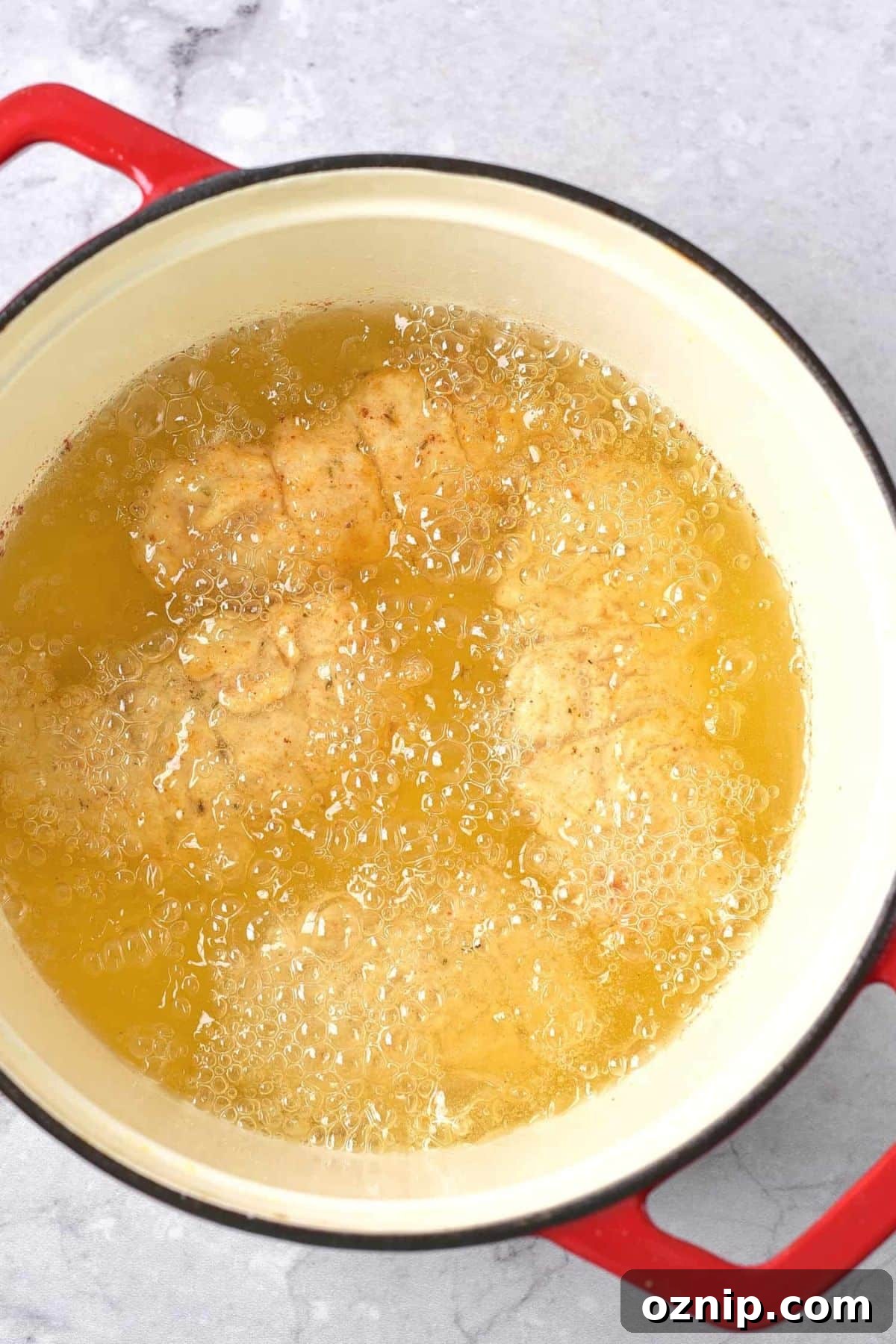 Gluten-Free Fried Chicken (Dairy-Free) Deep frying chicken in a large pot of oil.