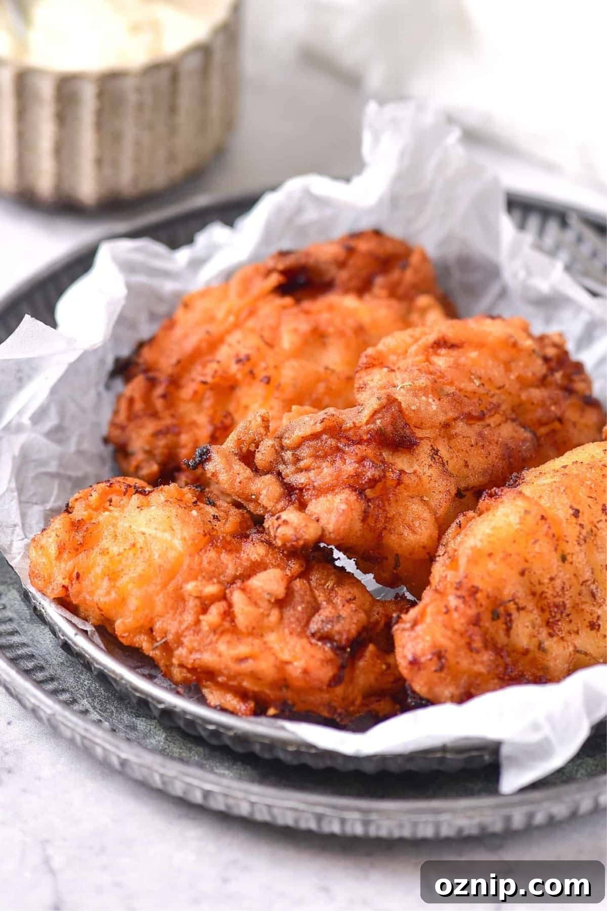 Gluten-Free Dairy-Free Fried Chicken Recipe Gluten-free dairy-free fried chicken on parchment-lined plates.