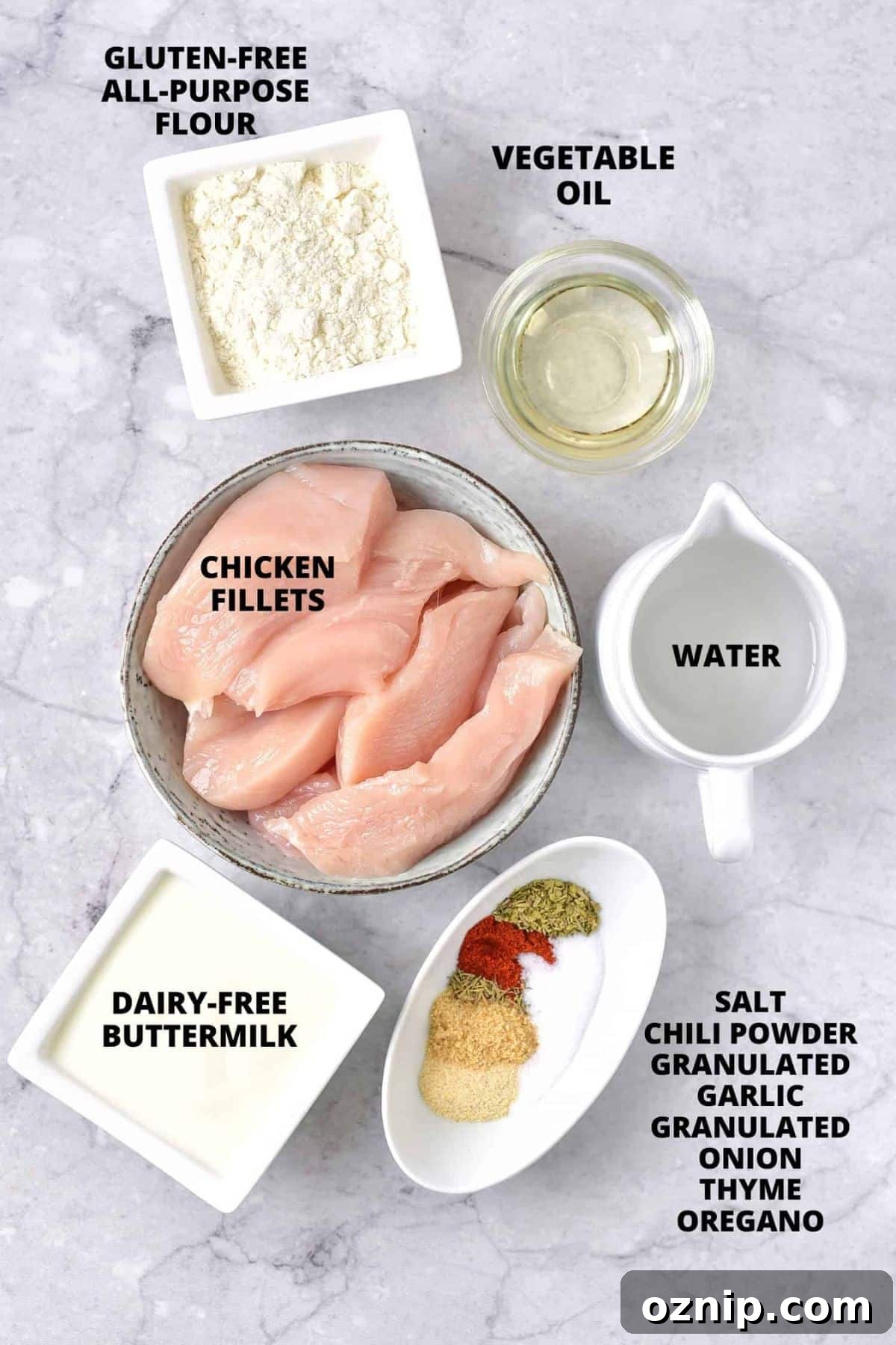 Gluten-Free Dairy-Free Fried Chicken Ingredients for gluten-free fried chicken recipe laid out on marble board.