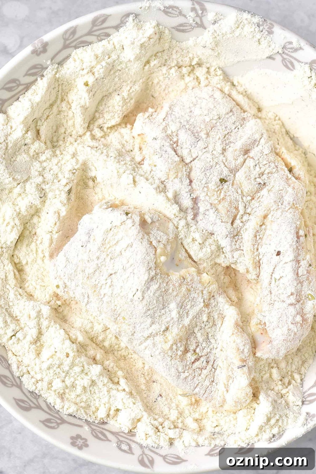 Gluten-Free Fried Chicken (Dairy-Free) Coating chicken in flour mixture.