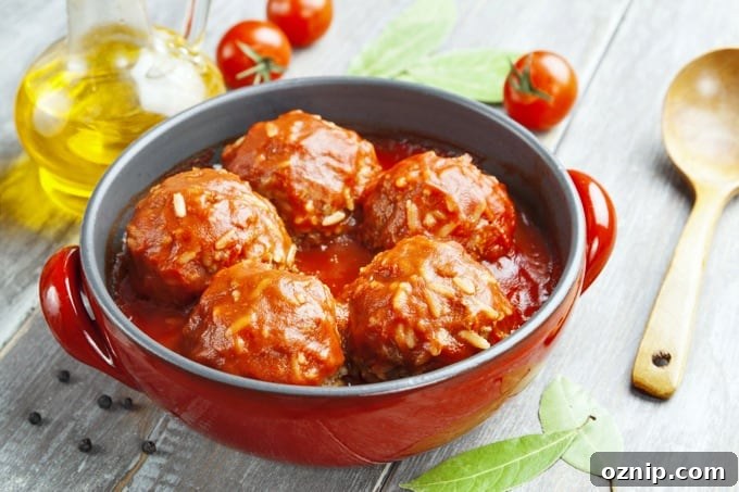 Meatballs with rice and tomato sauce in a red pot.