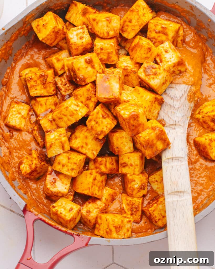How to Make Paneer at Home photo of paneer in a pan with sauce.