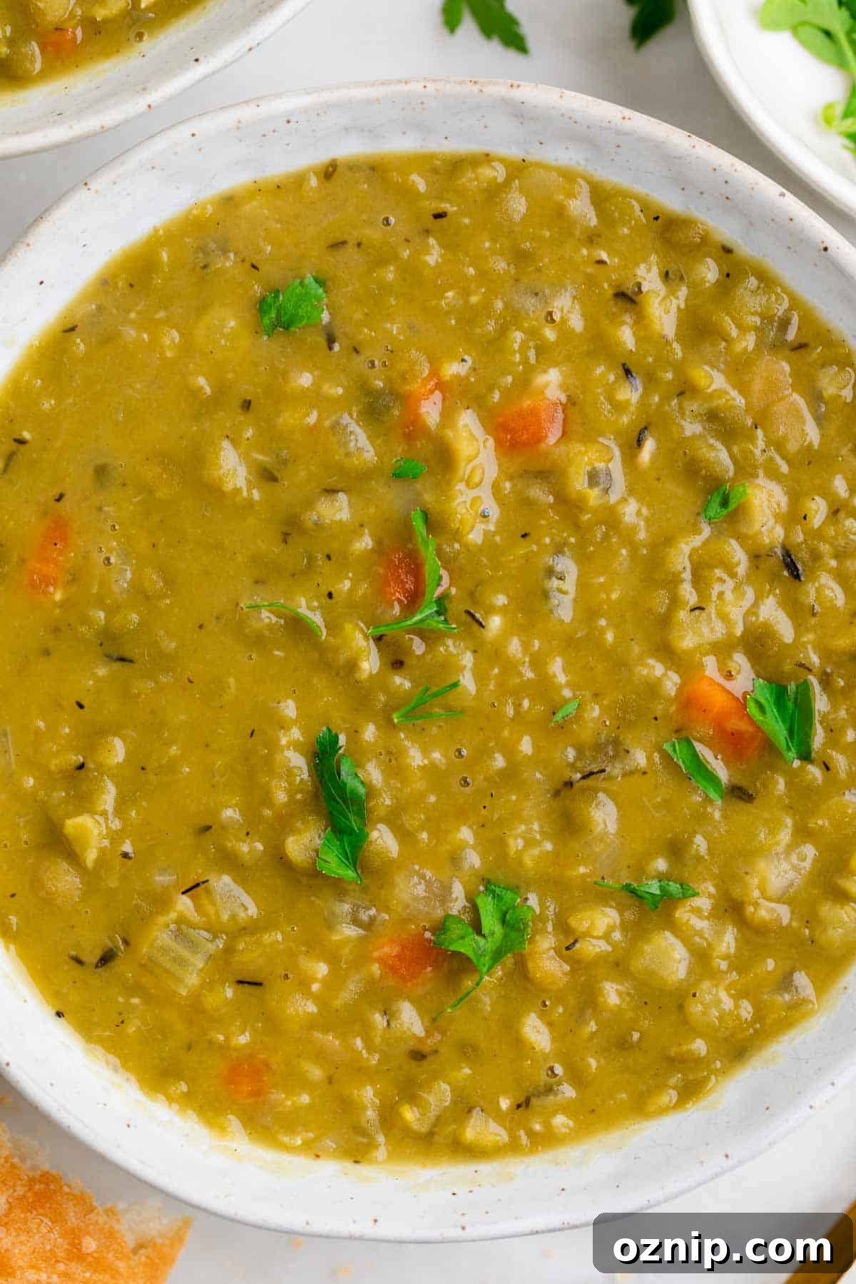 Hearty Vegan Split Pea Soup Recipe 9 Bowl of vegan split pea soup topped with parsley.