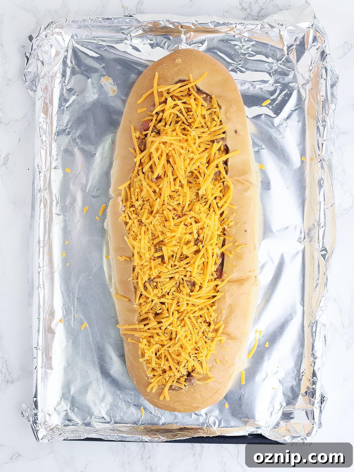 Bacon Cheeseburger Stuffed French Bread Recipe 12 unbaked bacon cheeseburger stuffed French bread topped with shredded cheddar cheese