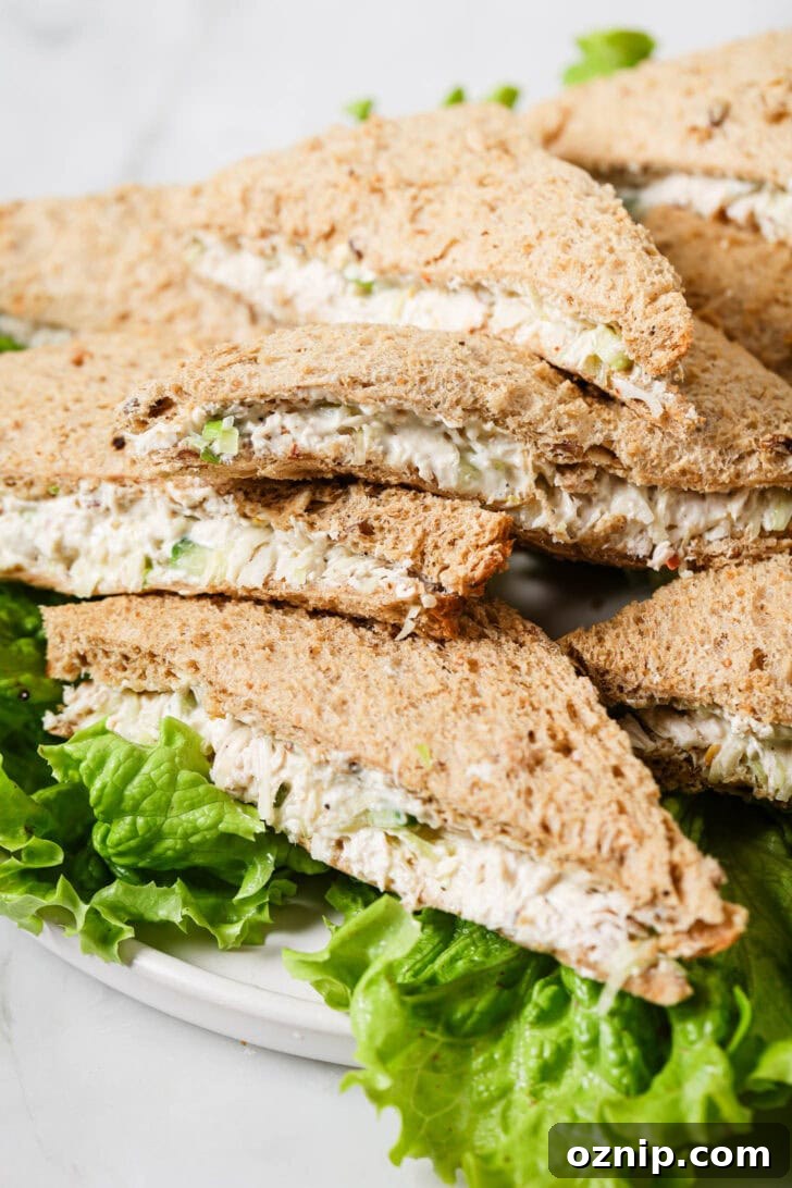 Platter of Chicken Sandwiches on a bed of lettuce.