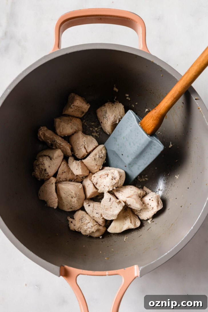 Cooked chicken in a pot for Chicken Sandwiches.