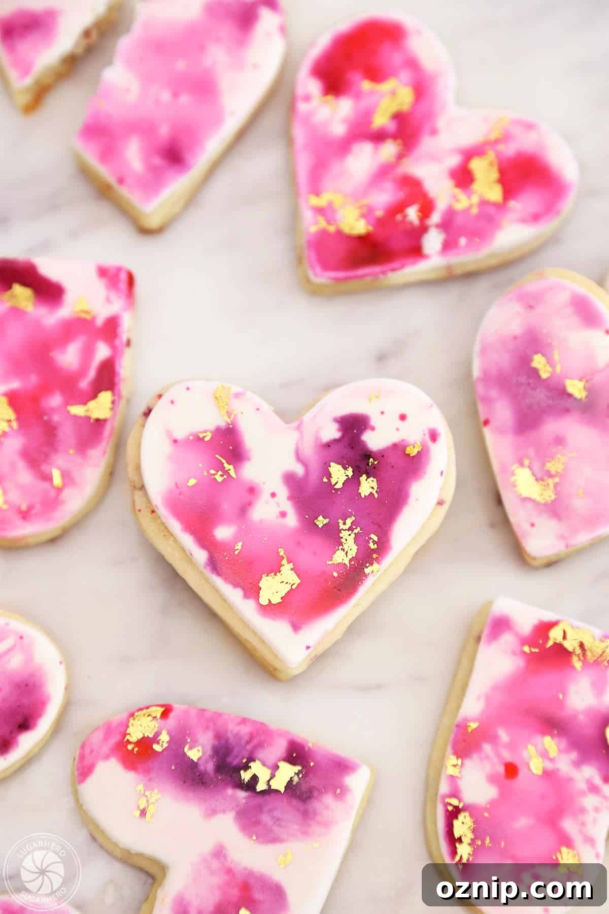 How to Make Watercolor Rose Sugar Cookies 2 Top view of Watercolor Rose Sugar Cookies on a marble surface.