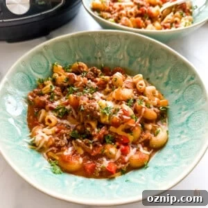 Instant Pot goulash in a green serving bowl.