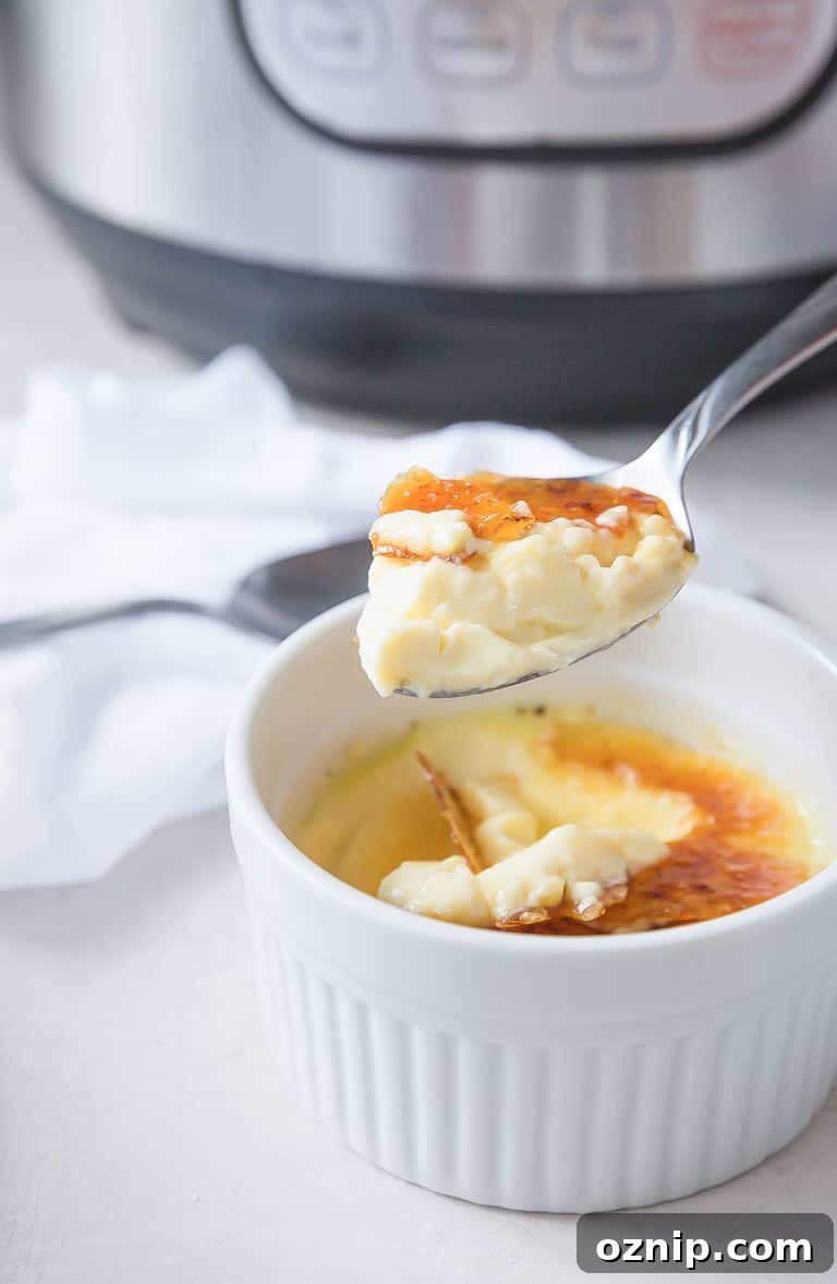 close up of a serving of Instant Pot Creme Brulee with a spoon scooping out one bite.