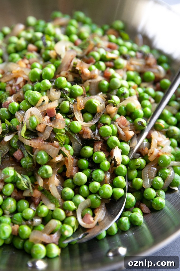 Peas and Pancetta Holiday Side Dish Recipe 4 Large skillet filled with sauteed pancetta and shallots with cooked sweet peas and garnished with mint.