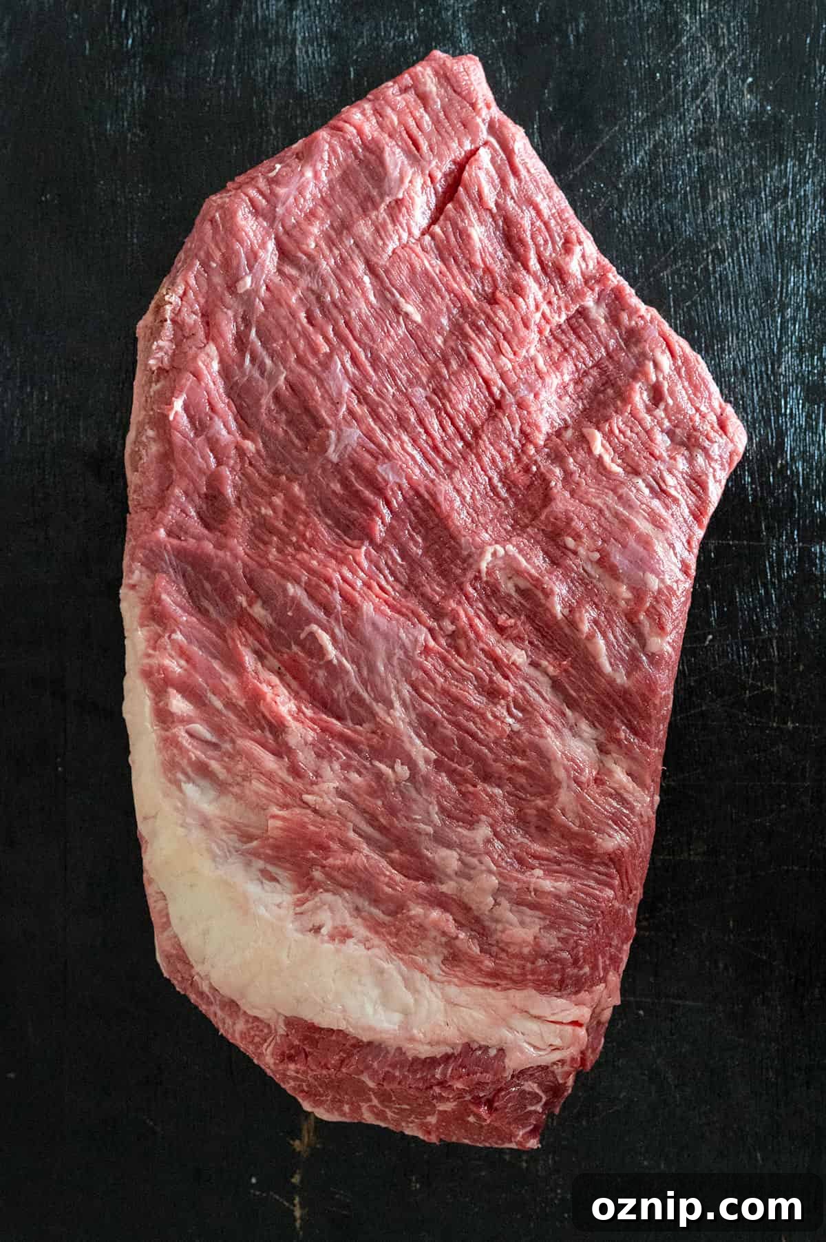 trimmed brisket on black background.