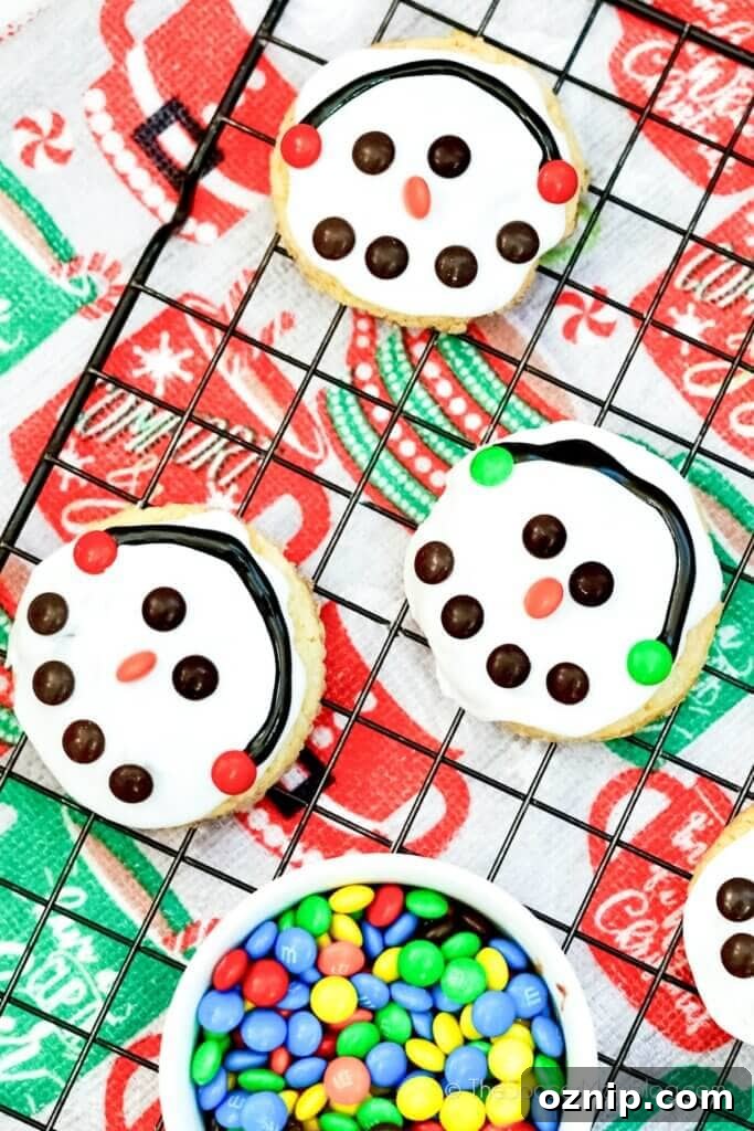 Three Snowman Cookies on a wire rack