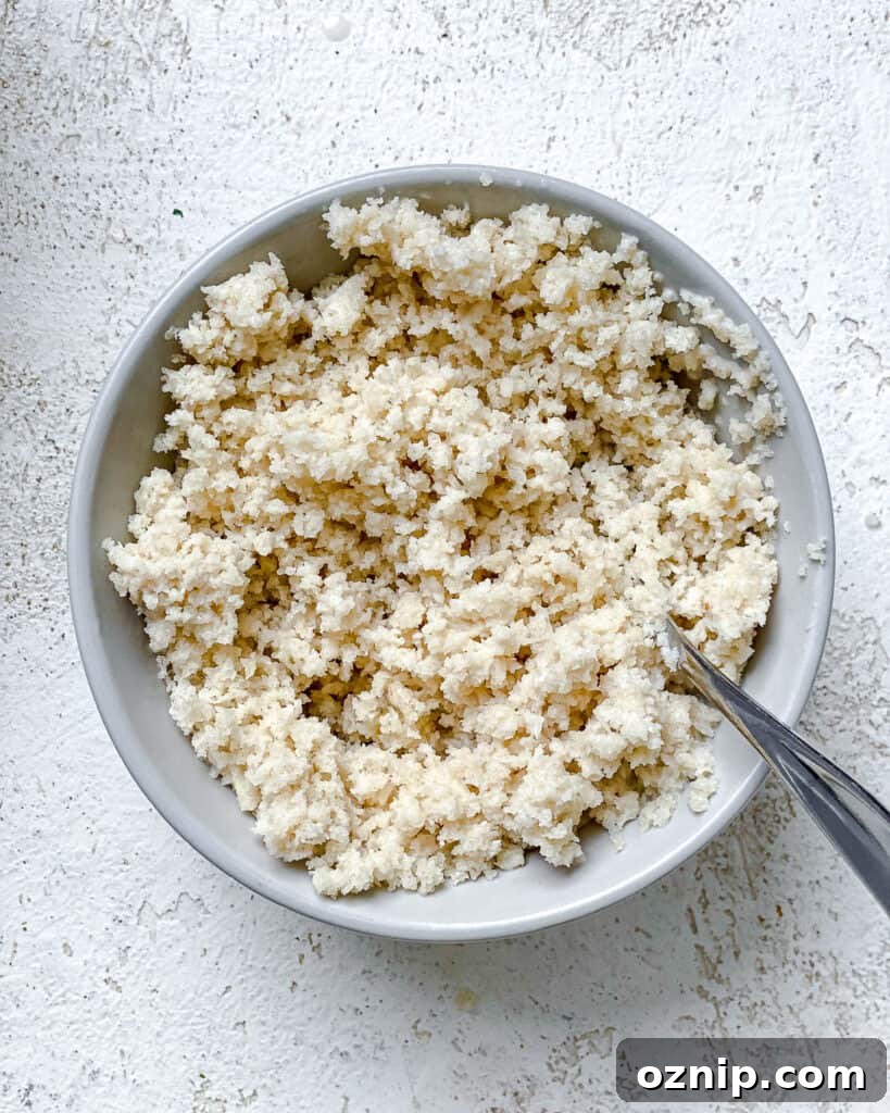 process shot of mixing breadcrumbs together in a bowl