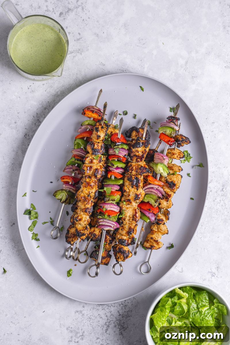 Greek Chicken Kebab Bowl with Tzatziki and Lemon Rice 11 skewered chicken on a platter.