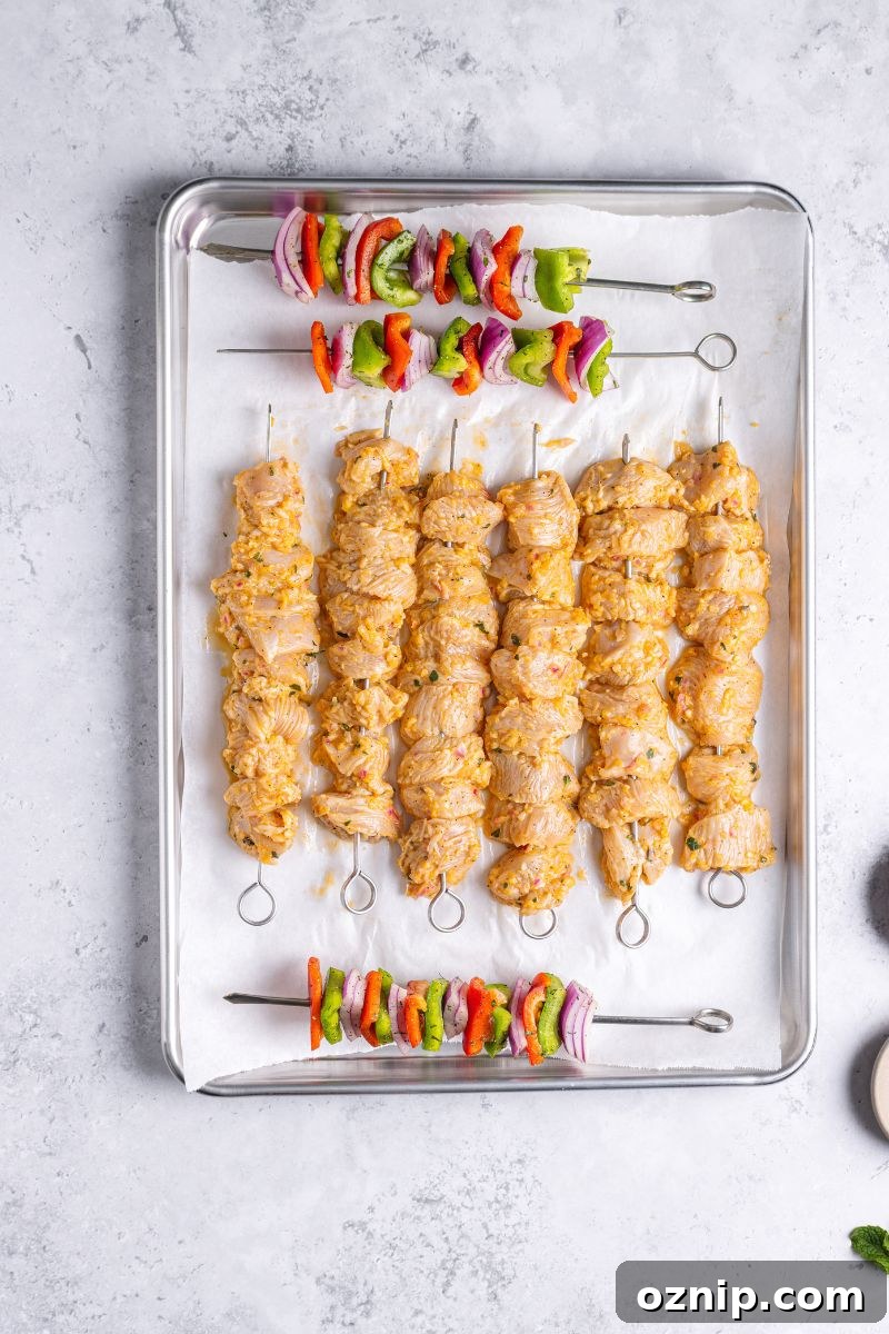 Greek Chicken Kebab Bowl with Tzatziki and Lemon Rice 7 assembled chicken and veggies on skewers