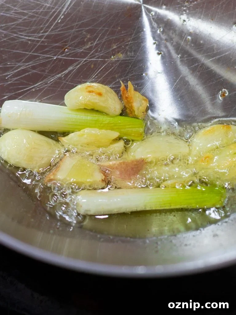 scallions, ginger, and garlic frying in oil